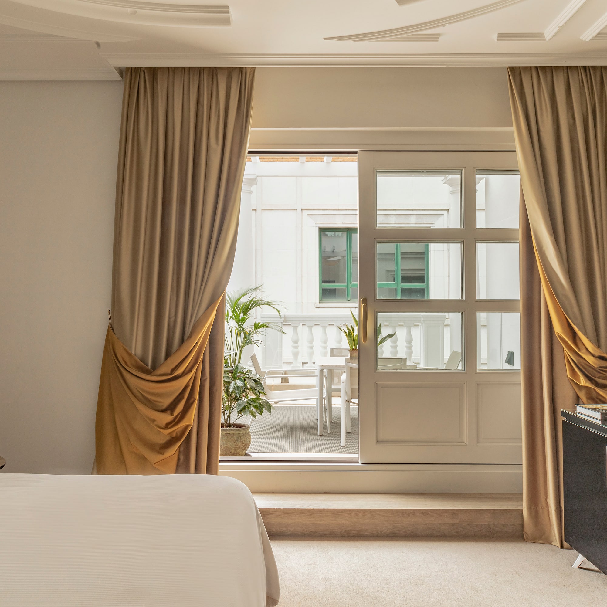 a bedroom with a bed and a piano and a glass door