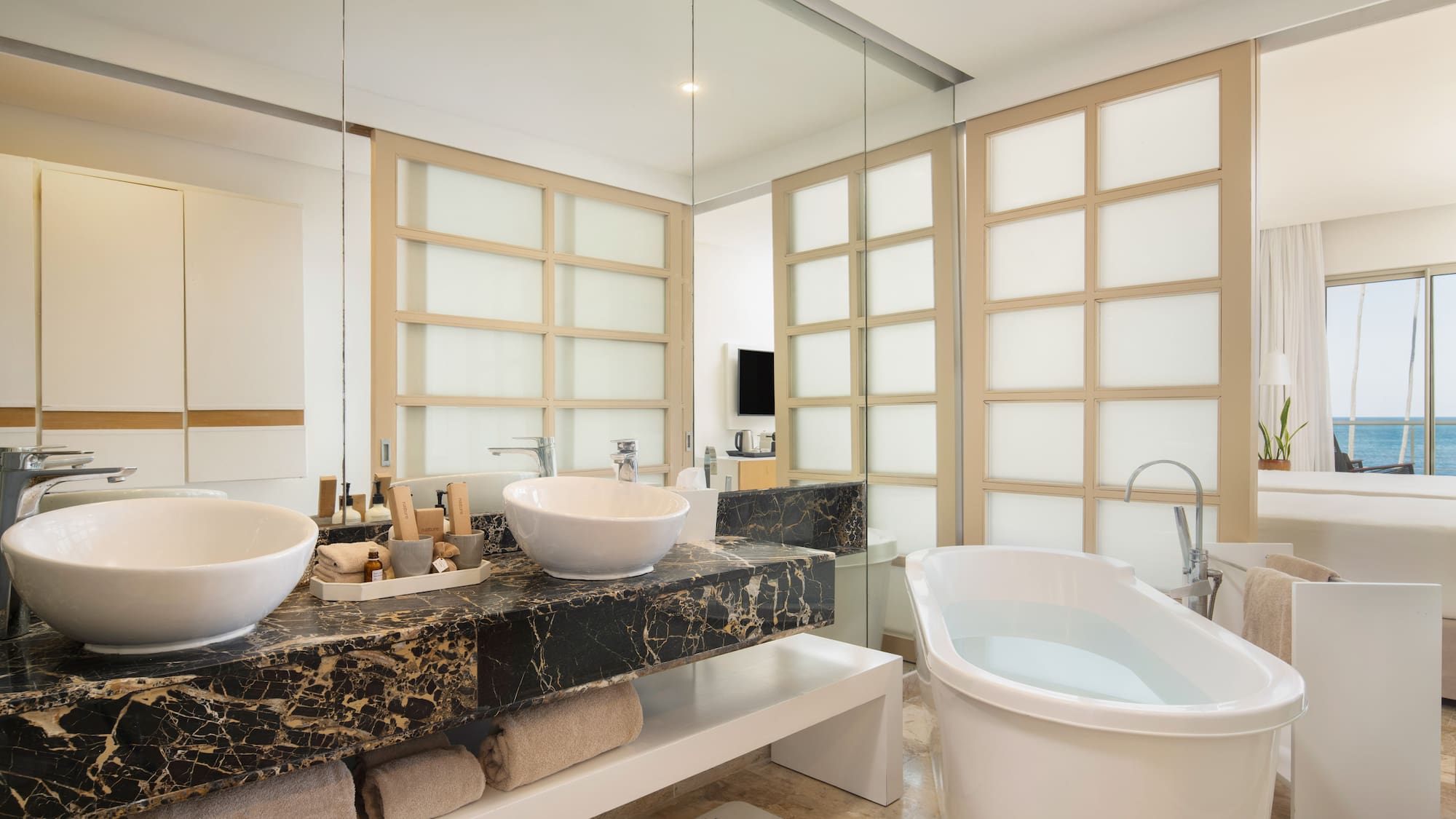a bathroom with a tub and sinks
