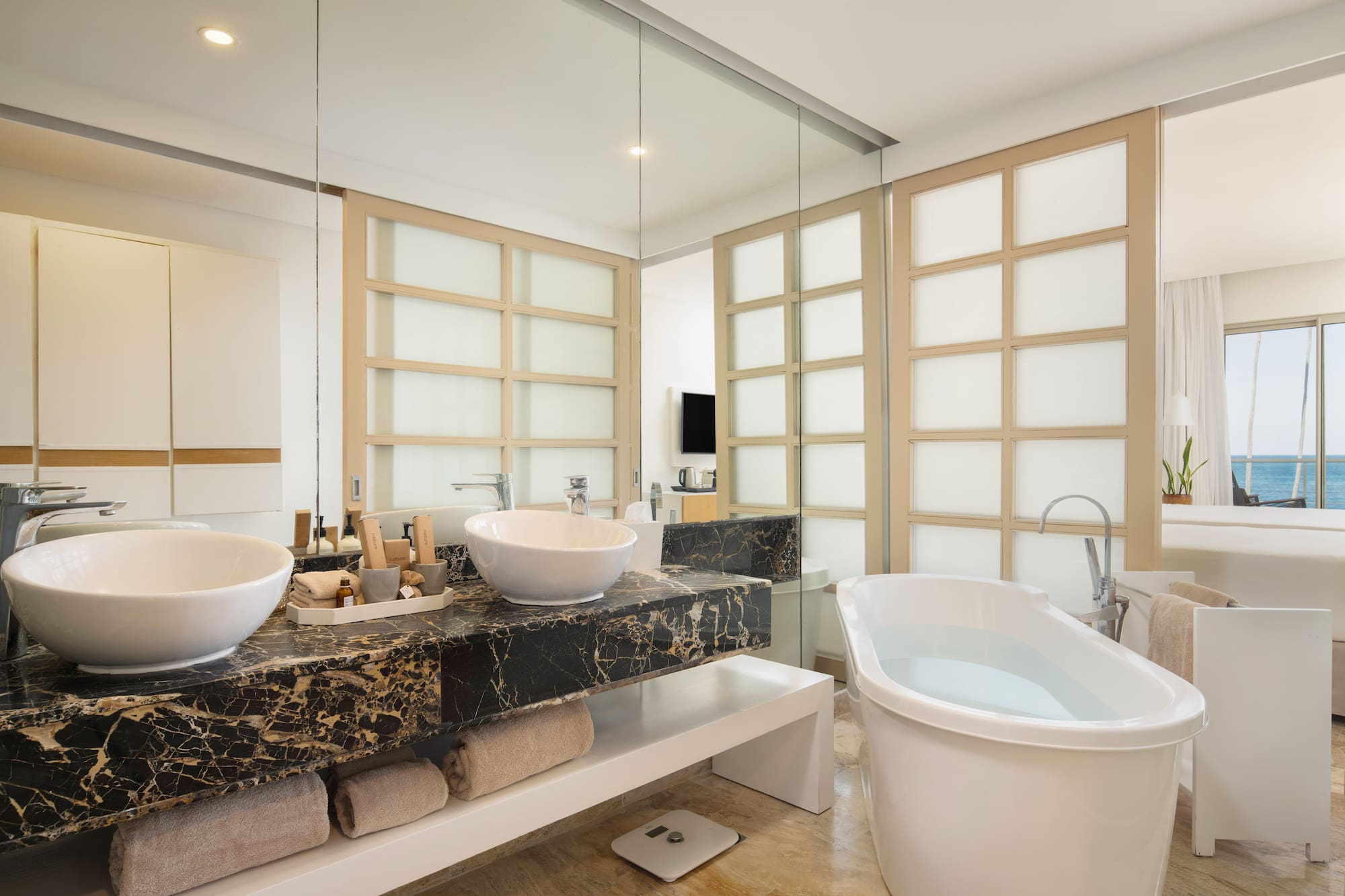 a bathroom with a tub and sinks