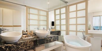 a bathroom with a tub and sinks