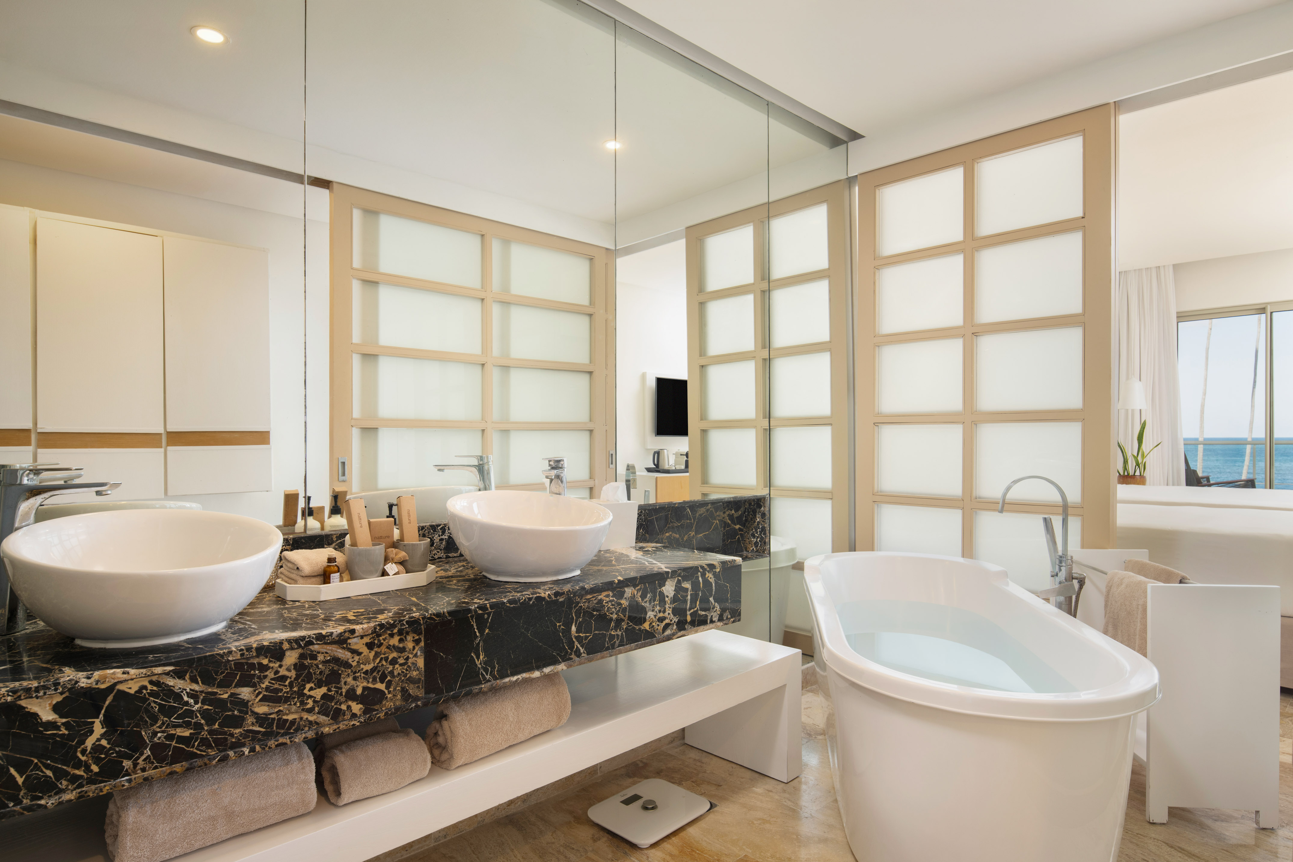 a bathroom with a tub and sinks
