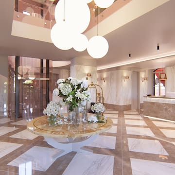 a room with marble flooring and a marble table with flowers