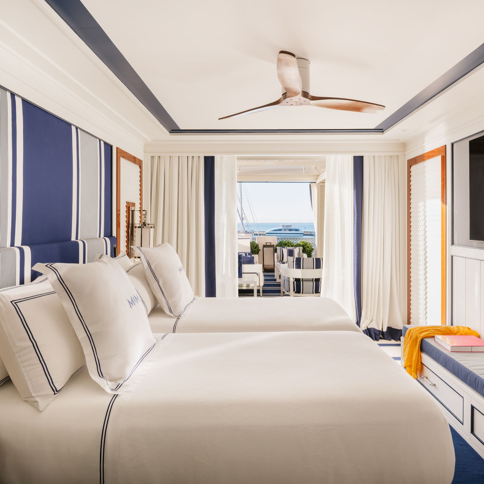 a room with two beds and a television