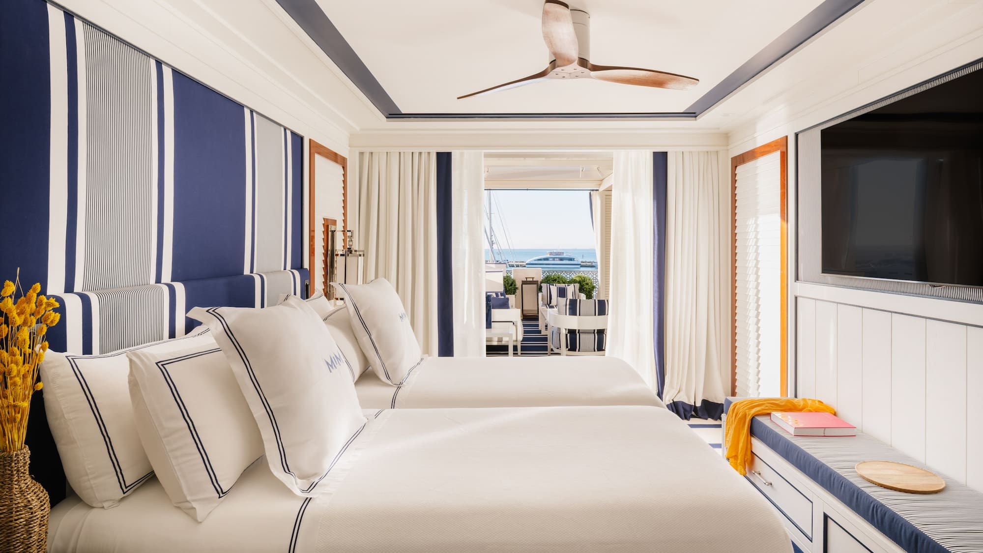 a room with two beds and a television