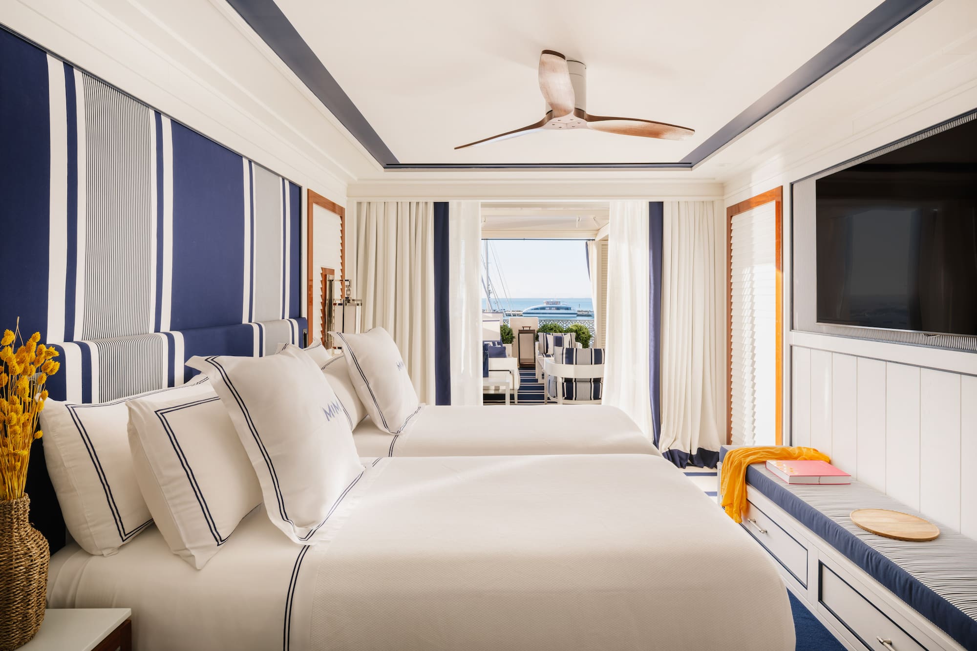 a room with two beds and a television