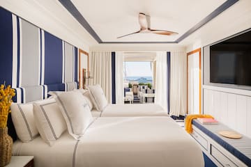 a room with two beds and a television