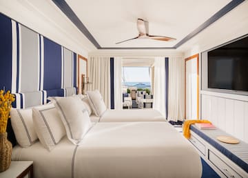 a room with two beds and a television