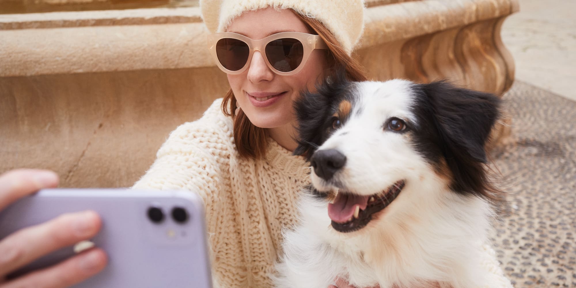 a woman taking a selfie with a dog