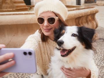 a woman taking a selfie with a dog