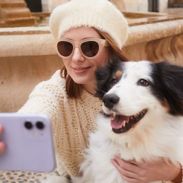 a woman taking a selfie with a dog
