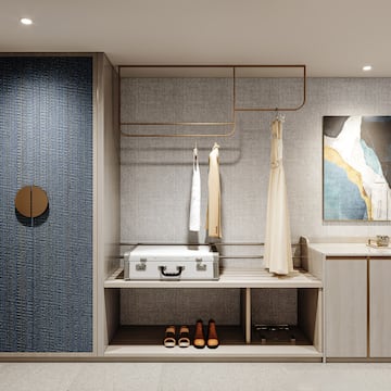 a room with a white suitcase and shoes on a shelf