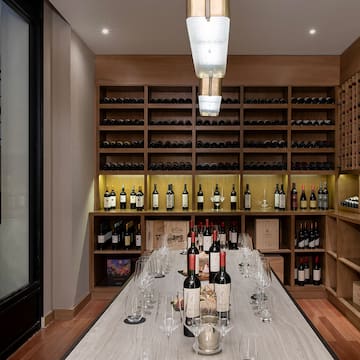 a wine cellar with wine glasses and bottles