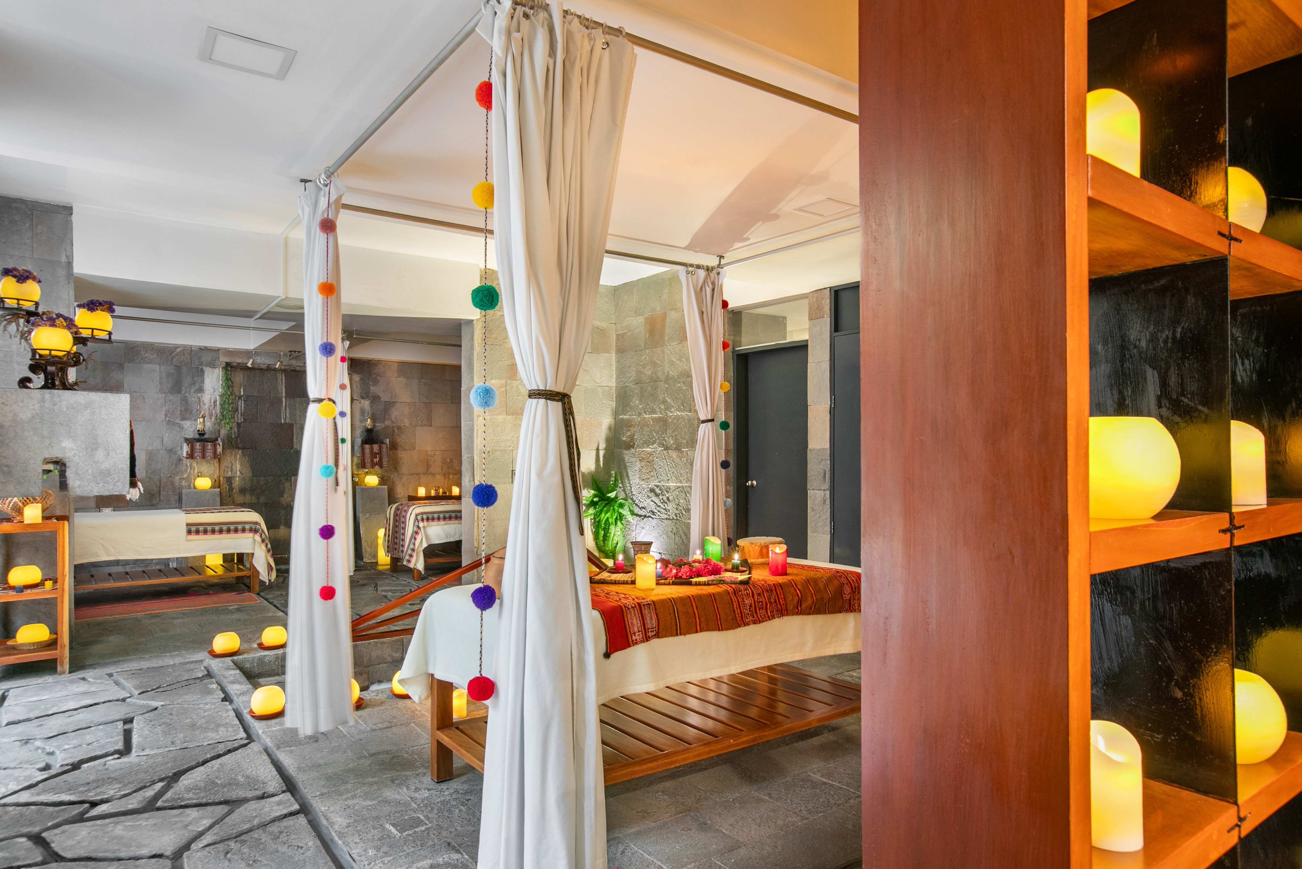 Serene spa massage room with canopy bed and lit candles. - Hotel Cusco La Paccha Affiliated by Meliá, Cusco