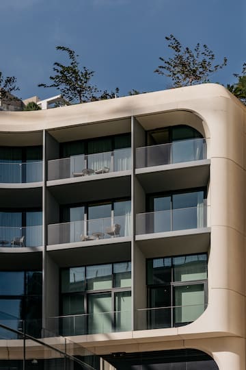 a building with balconies and trees