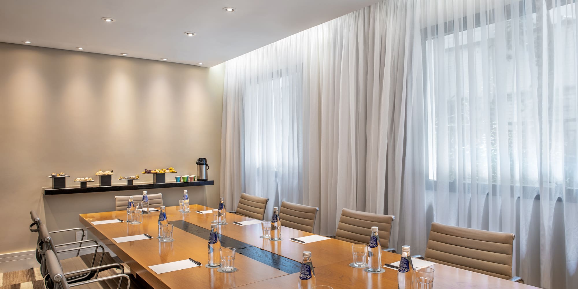 a conference room with a table and chairs