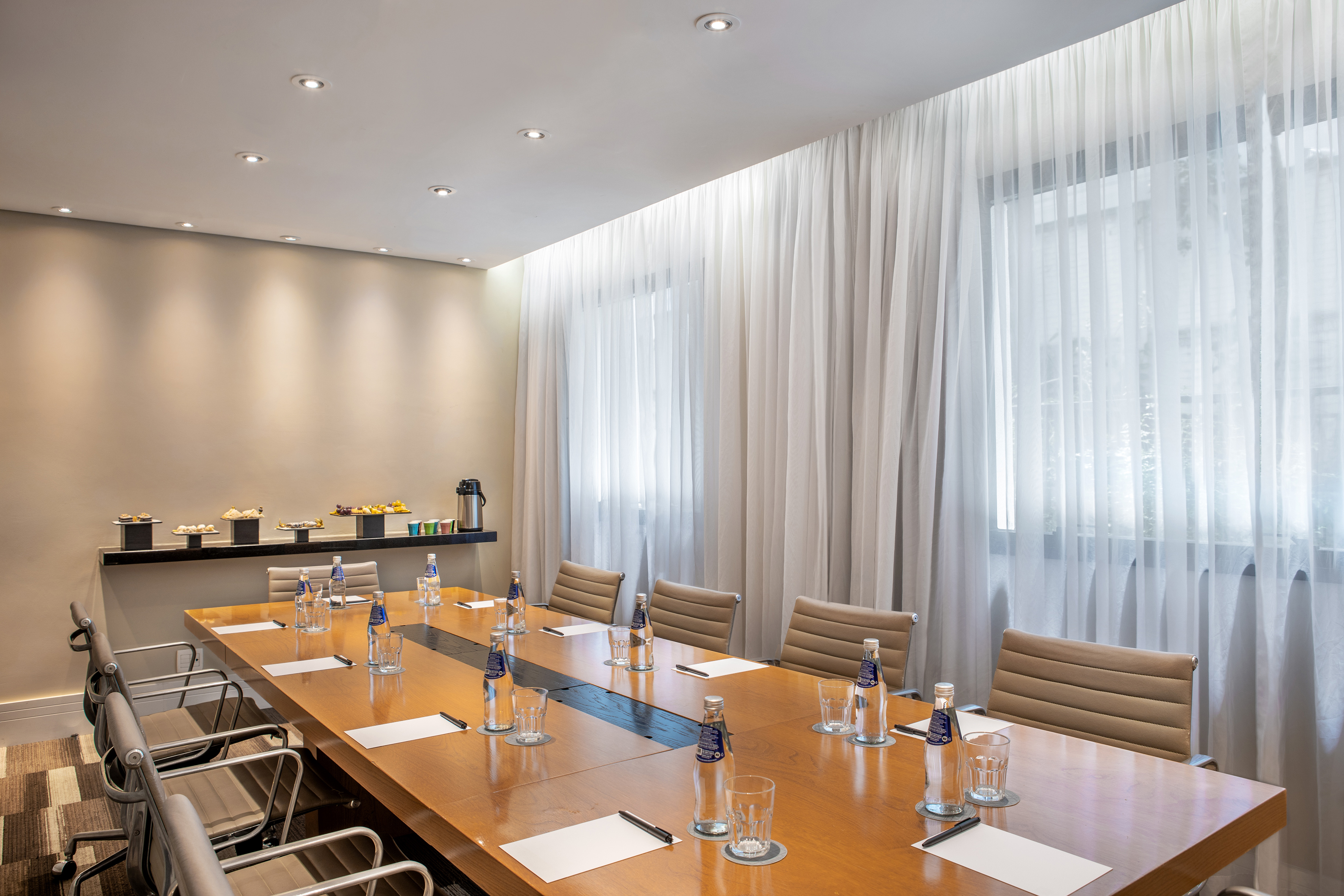 a conference room with a table and chairs