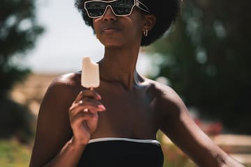 a woman in a garment holding an ice cream