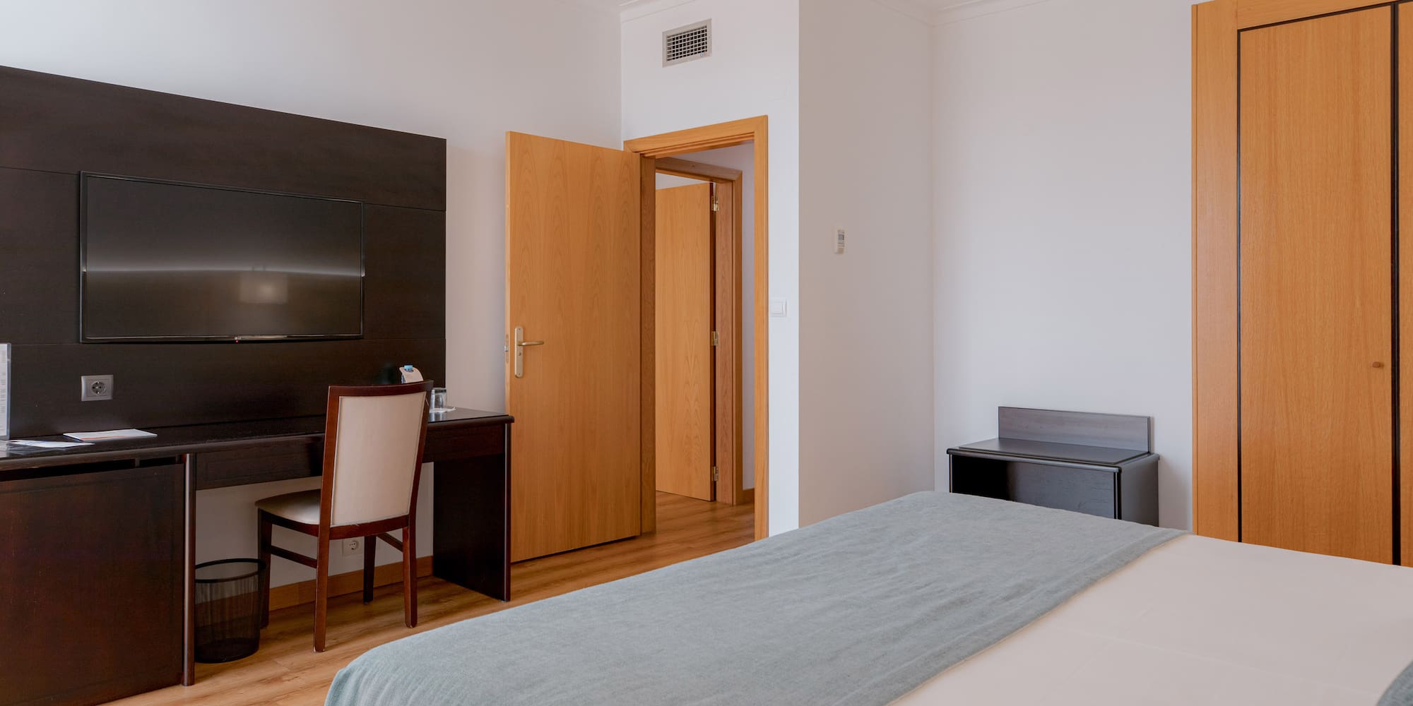 a bedroom with a bed and a desk