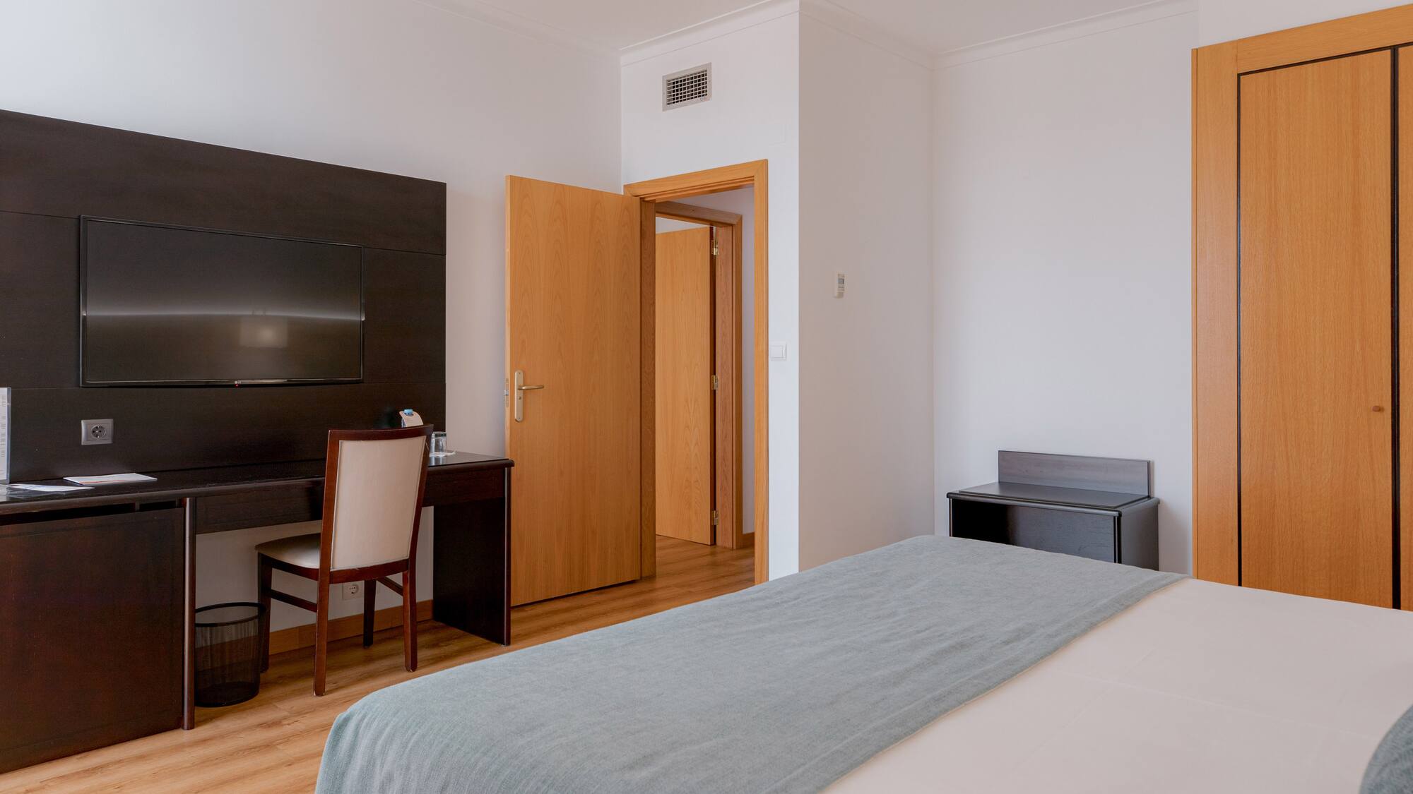 a bedroom with a bed and a desk