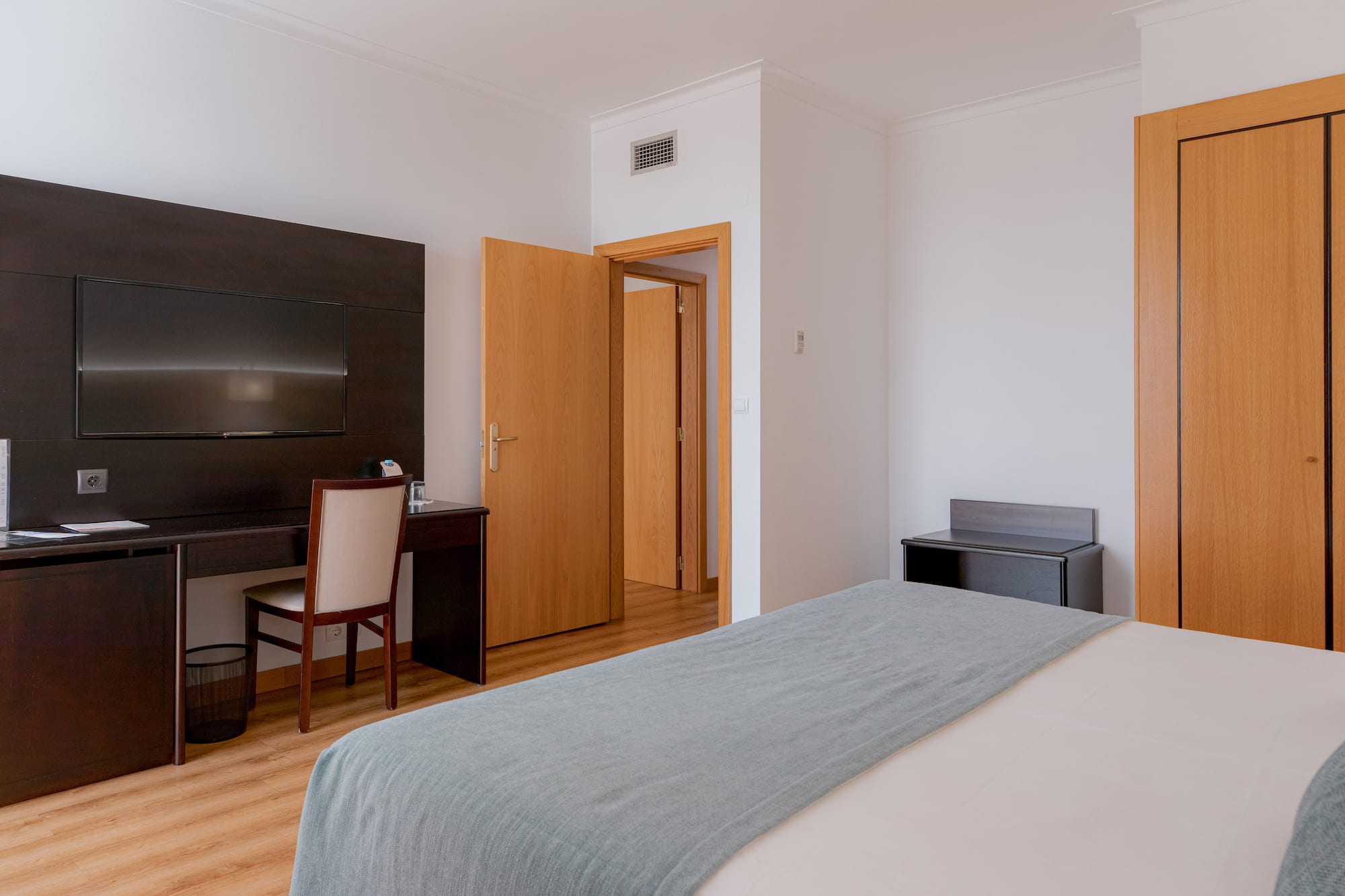 a bedroom with a bed and a desk