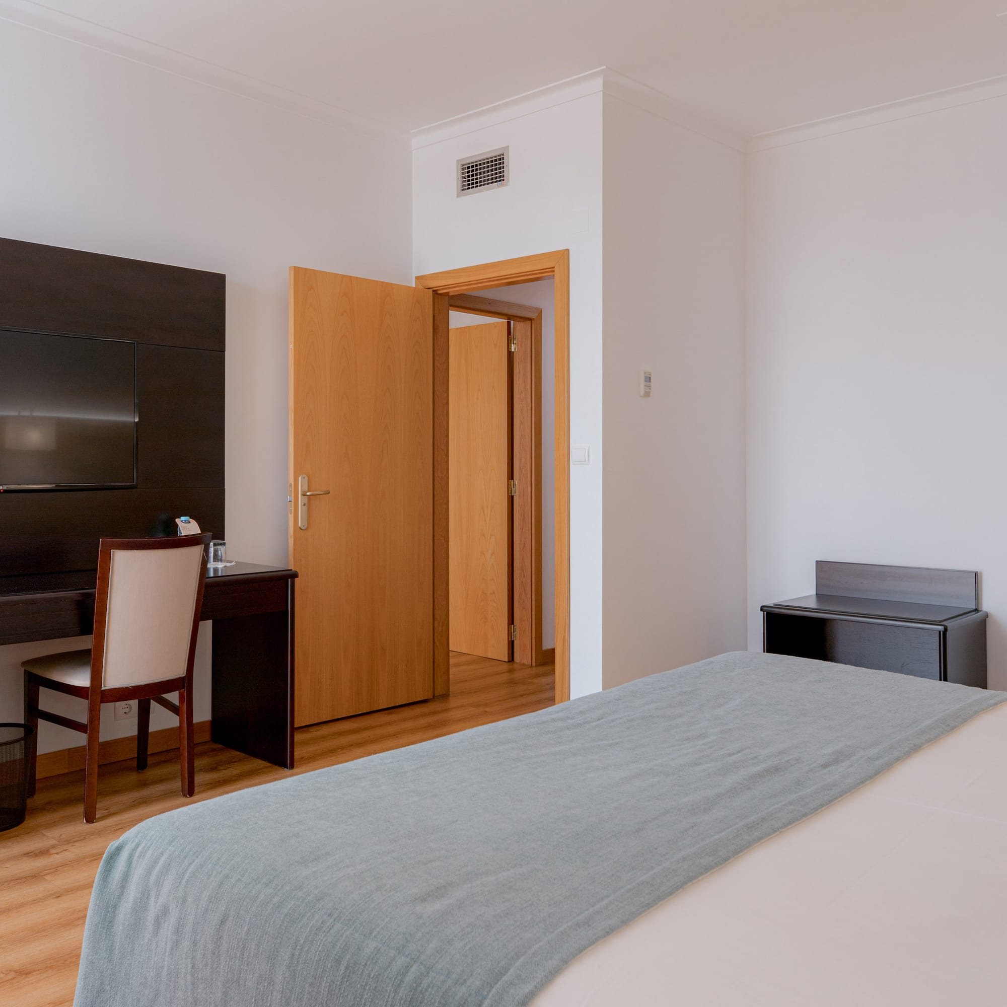 a bedroom with a bed and a desk