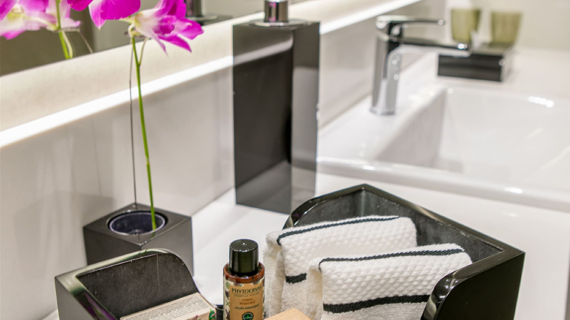 a black dish with towels and soap in it