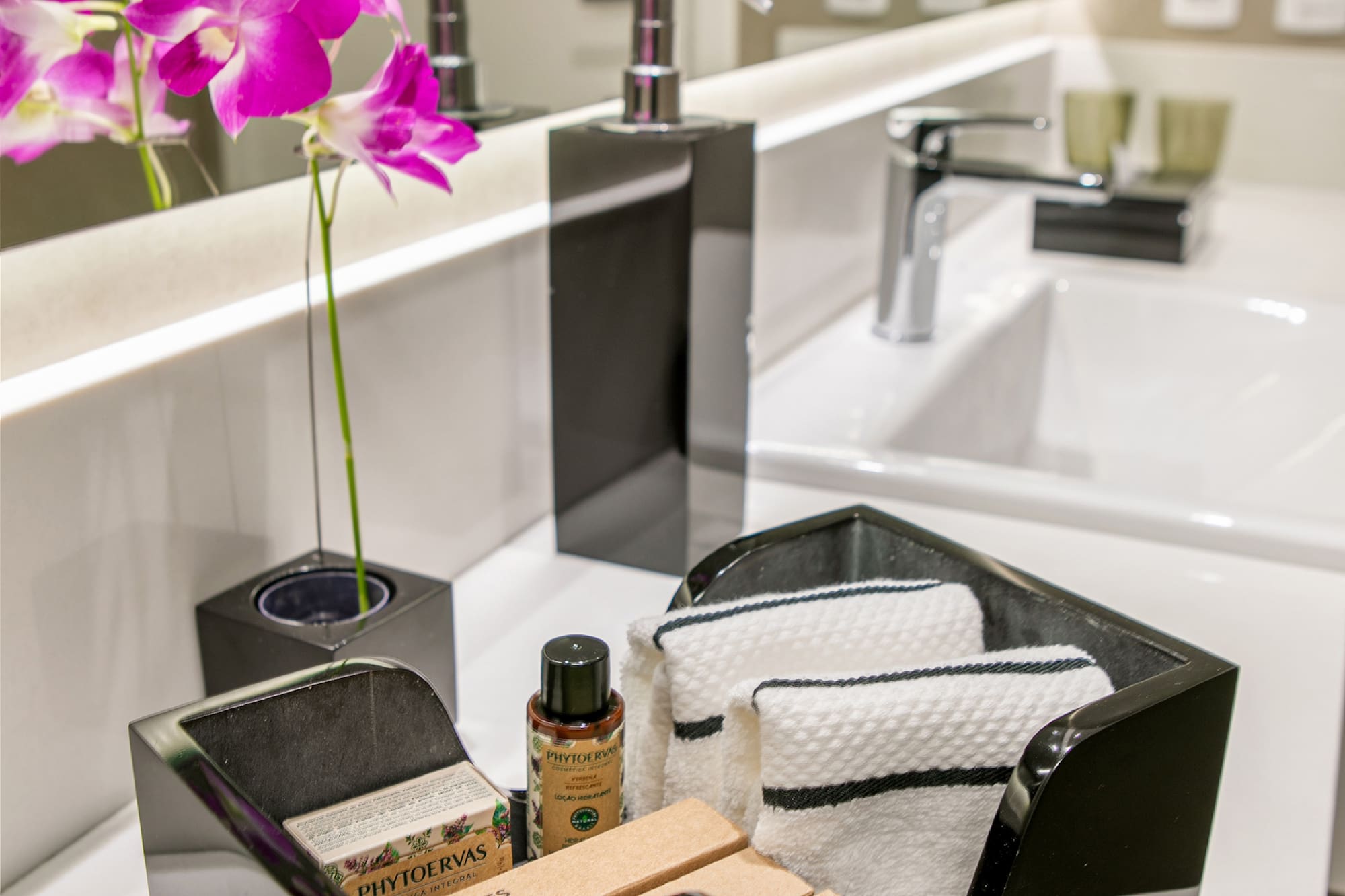 a black dish with towels and soap in it