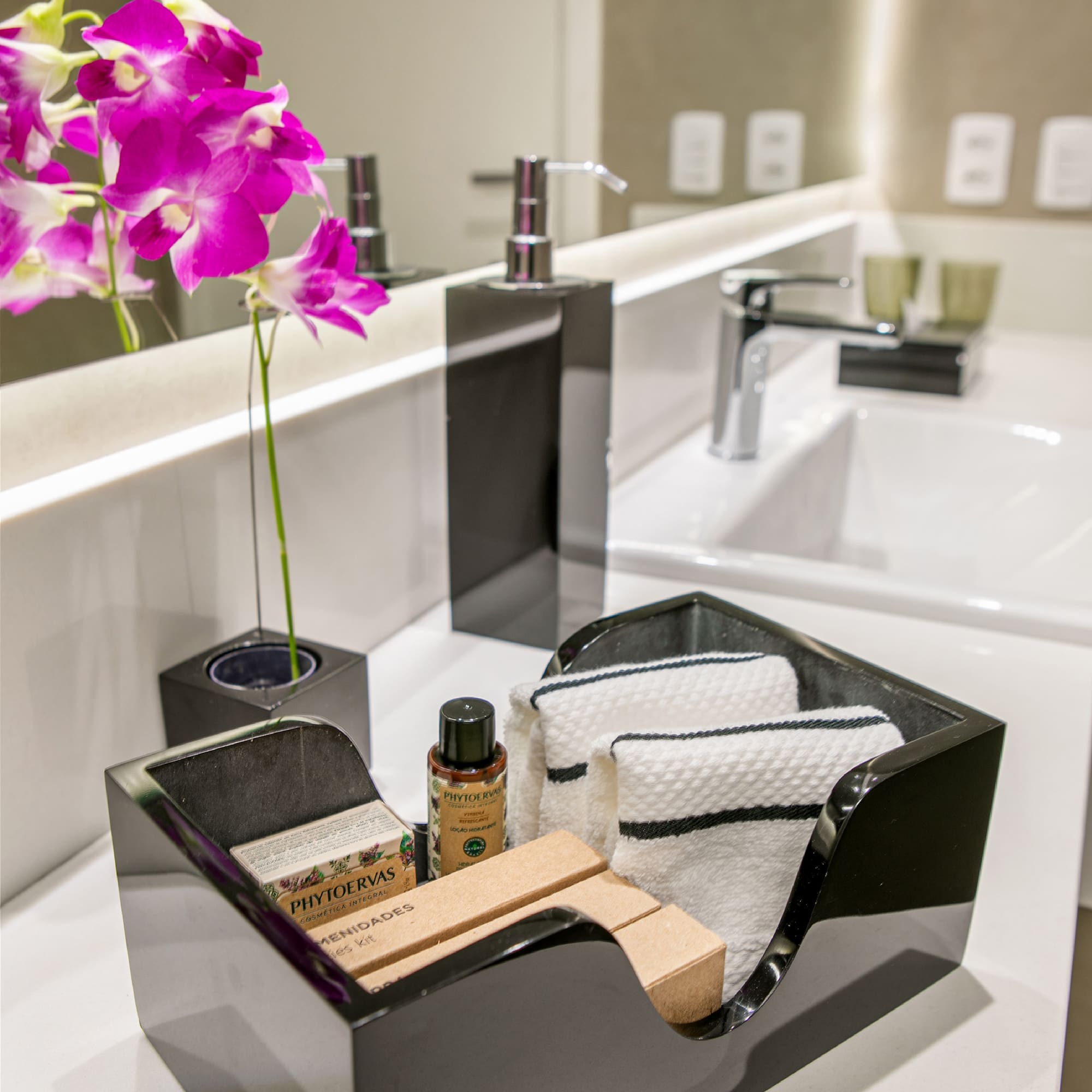 a black dish with towels and soap in it