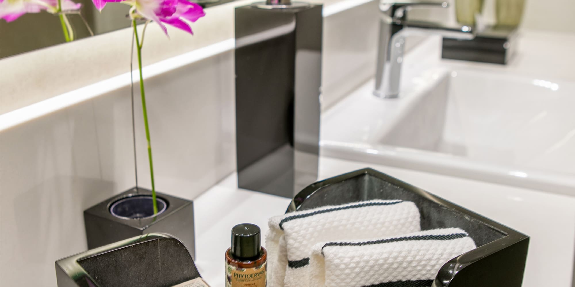 a black dish with towels and soap in it