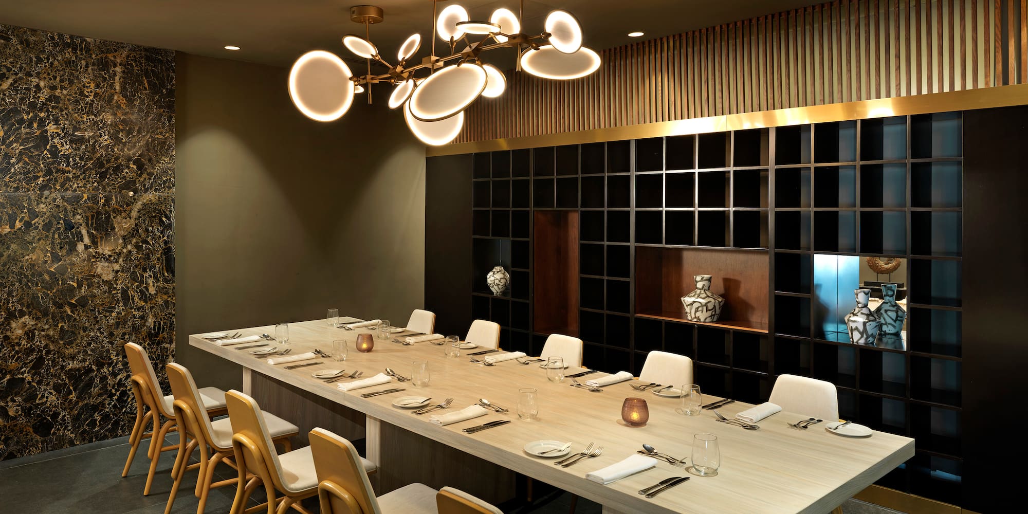 a long table with chairs and a chandelier