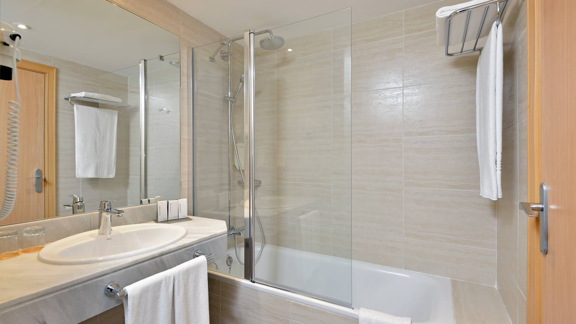 a bathroom with a shower and tub