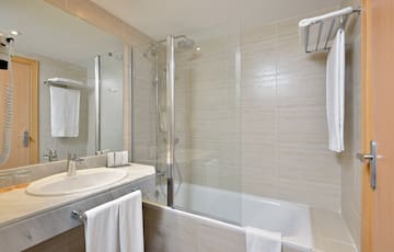 a bathroom with a shower and tub