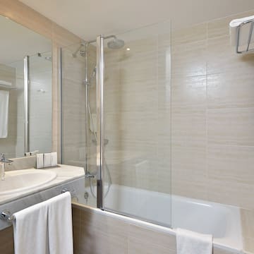 a bathroom with a shower and tub