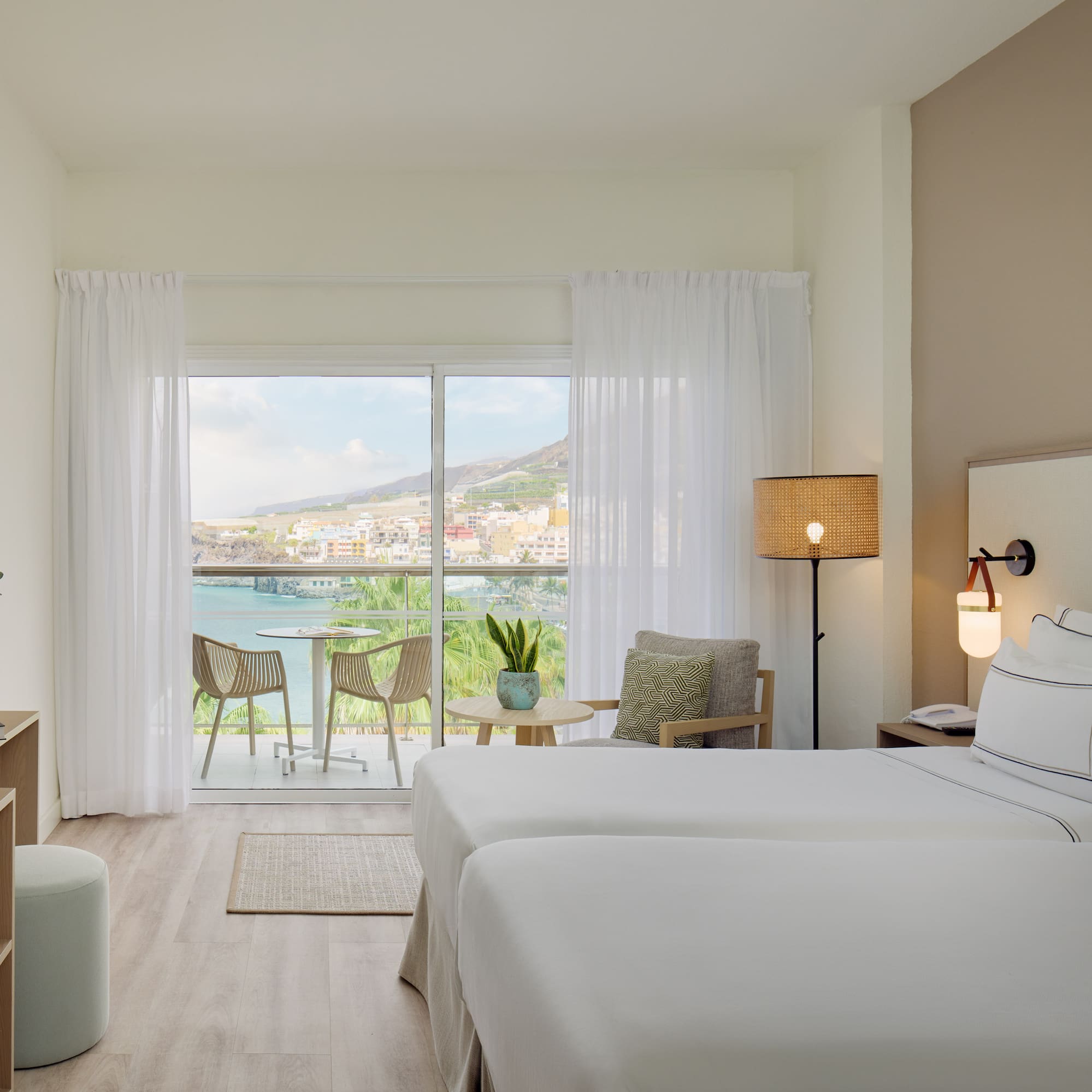 a room with two beds and a glass door