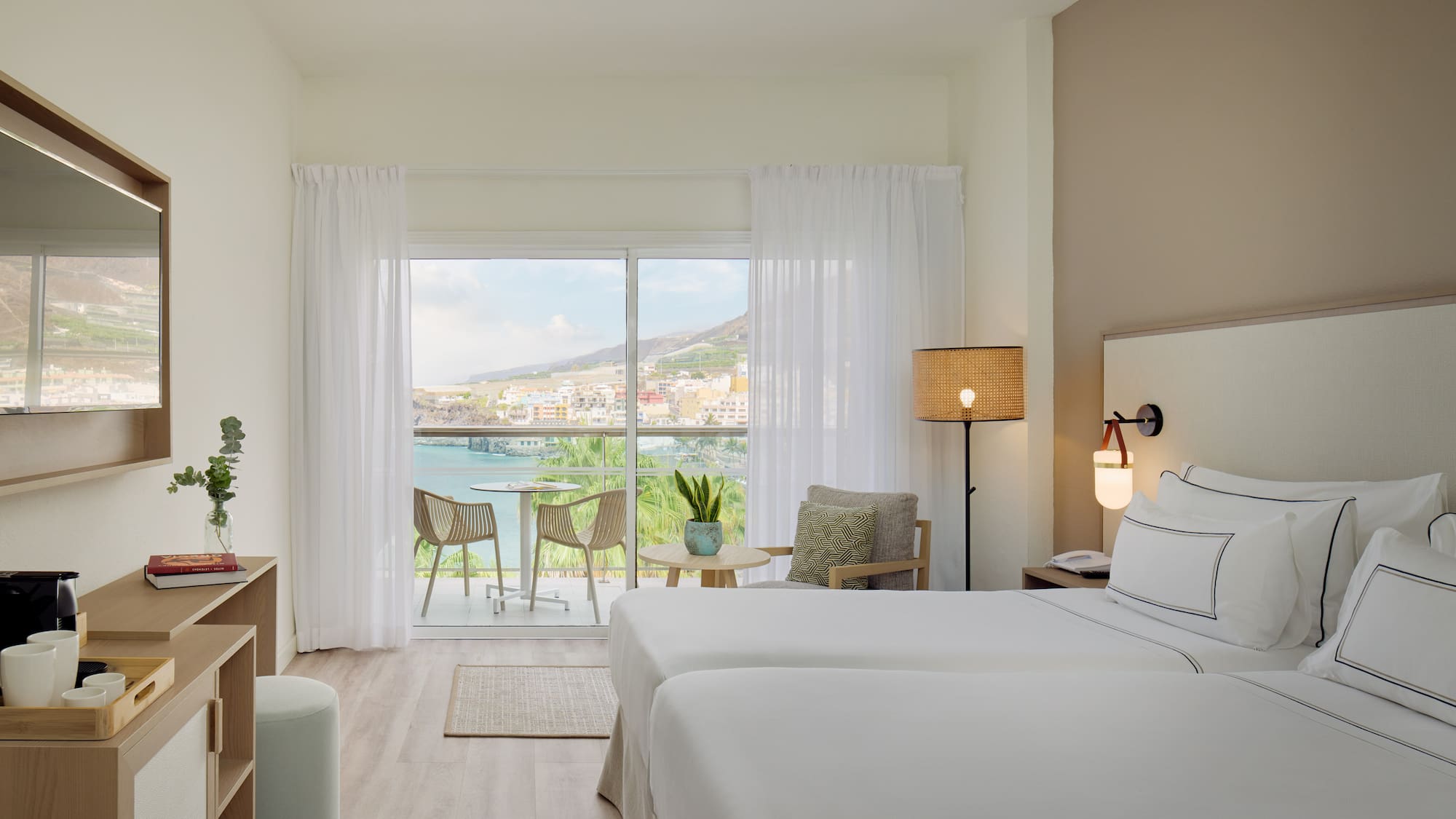 a room with two beds and a glass door