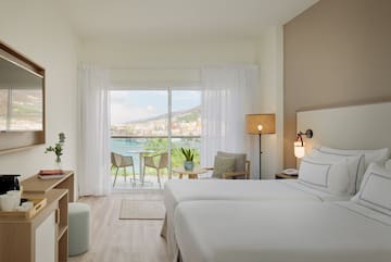 a room with two beds and a glass door