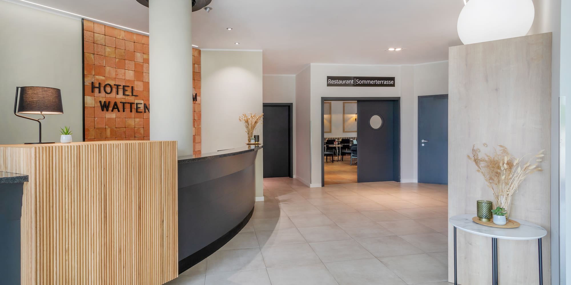 a lobby with a reception desk and a door