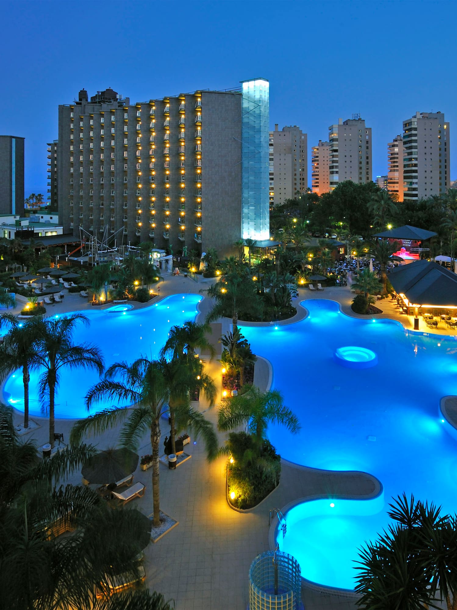 a pool with lights in the background