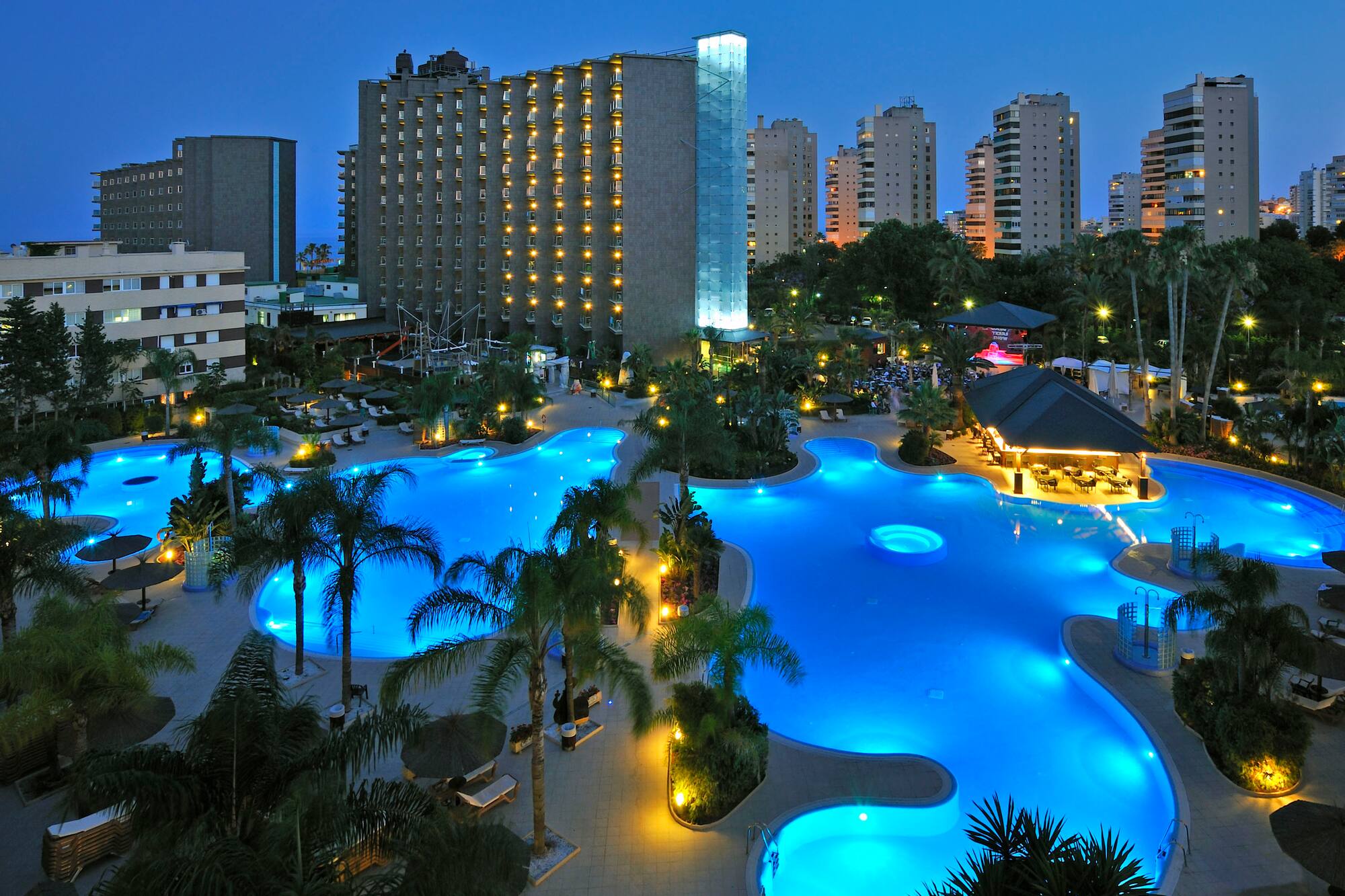 a pool with lights in the background