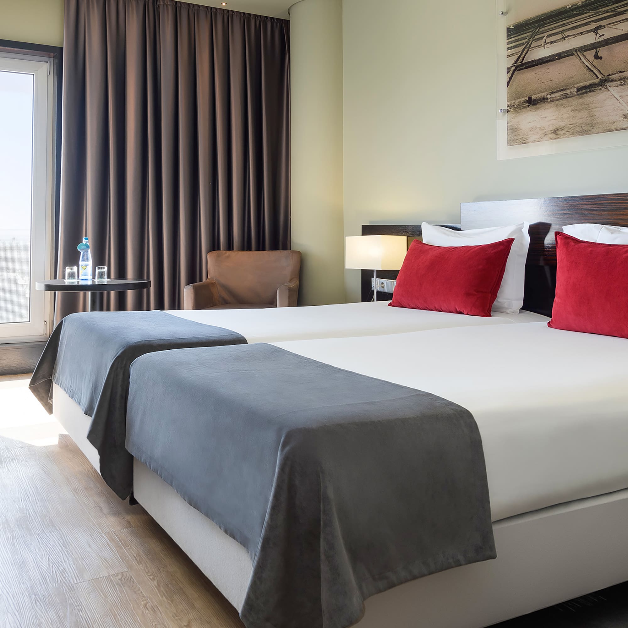 a room with two beds and a chair