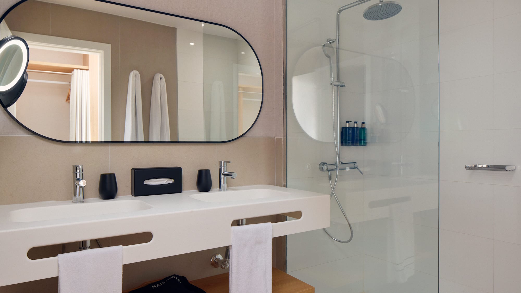 a bathroom with a mirror and shower