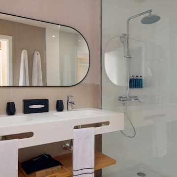 a bathroom with a mirror and shower