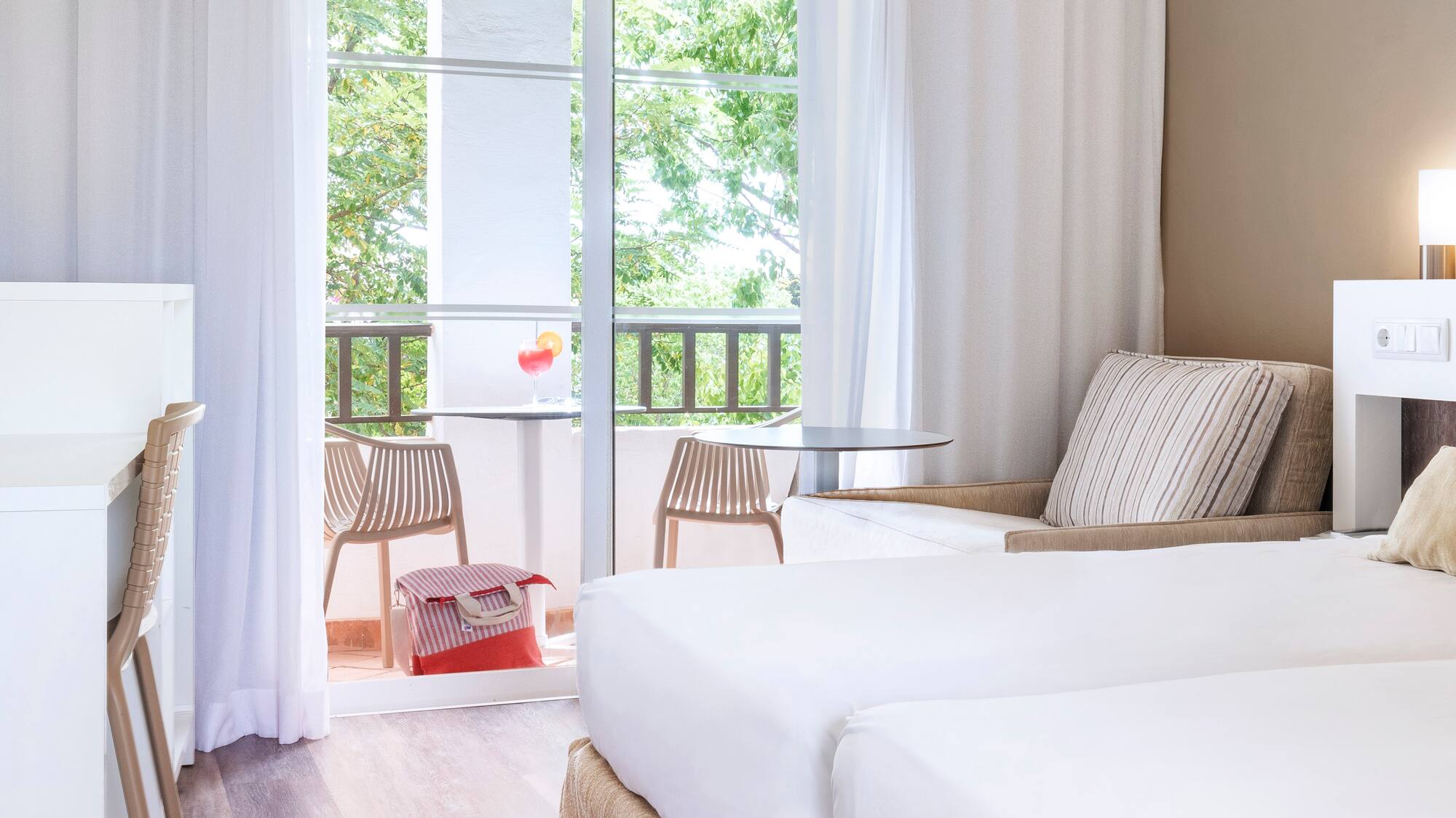 a room with two beds and a table and chairs