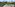 Luxury pool deck with cabana, lounge chairs, and tropical landscaping.