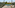 Luxury pool deck with cabana, lounge chairs, and tropical landscaping.