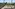 Luxury pool deck with cabana, lounge chairs, and tropical landscaping.