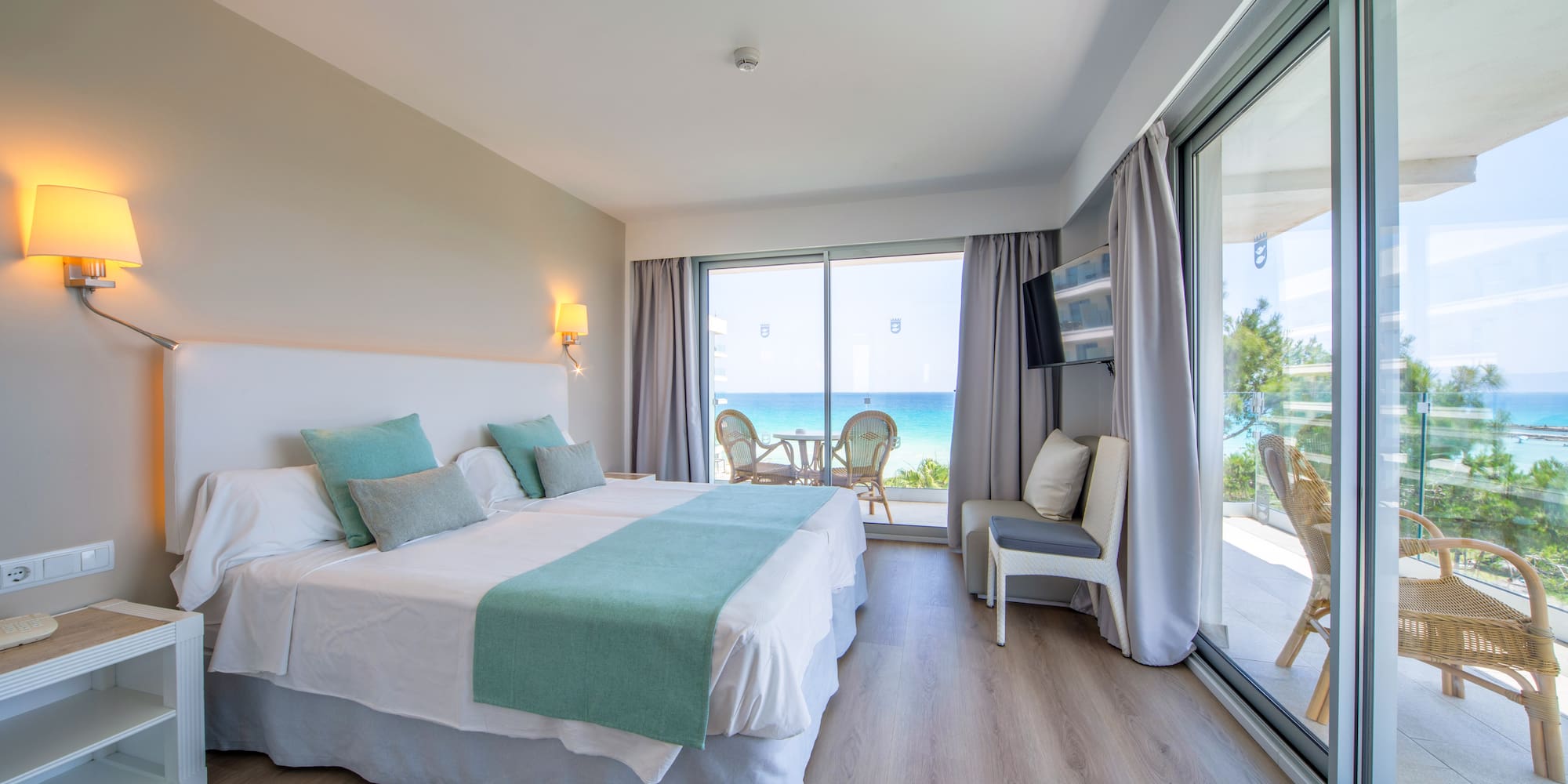 a room with a large bed and a glass door