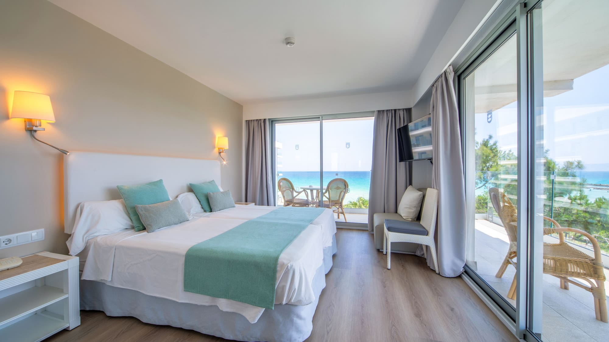 a room with a large bed and a glass door