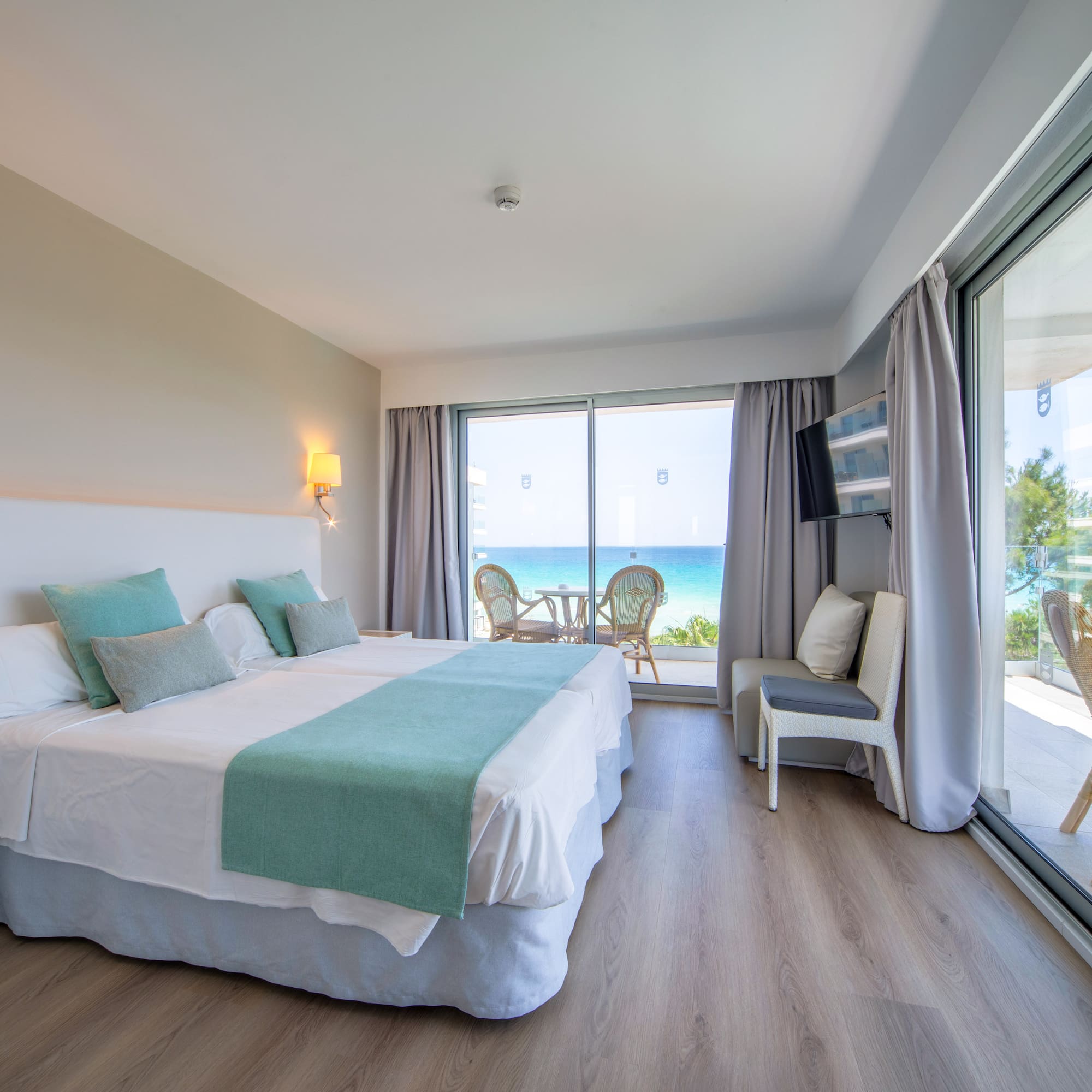 a room with a large bed and a glass door