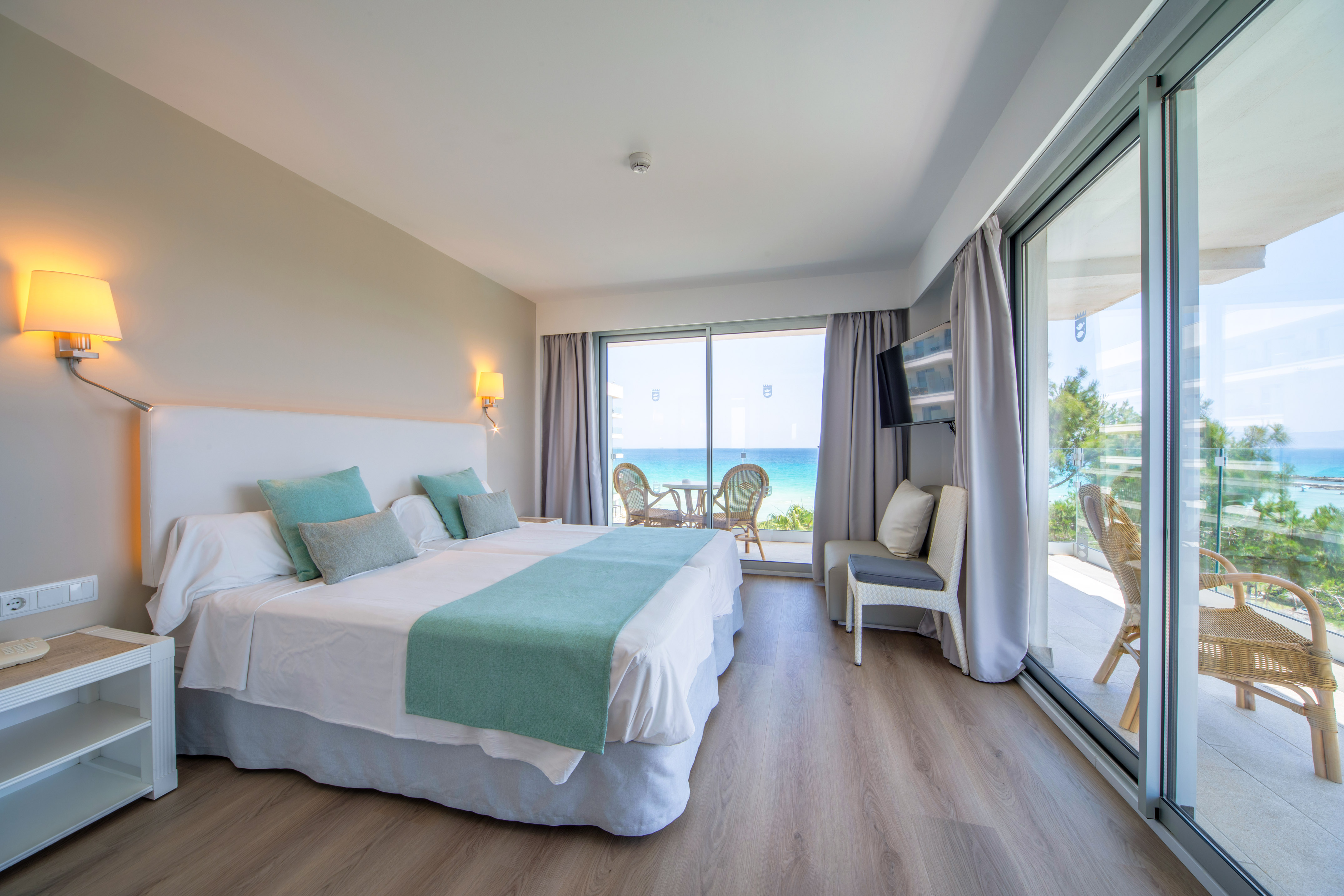 a room with a large bed and a glass door